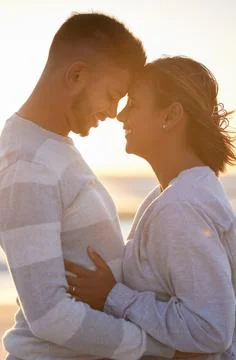 Couple, sunset and forehead touch for love, outdoor beach date and happy holiday Stock Photos