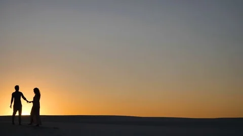 Couple at sunset in the desert Stock Footage 80651566