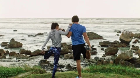 Couple support each other while stretching Stock Footage 76521590