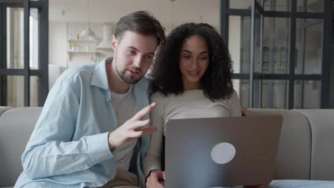 Couple Surprised During Video Call While Sitting With Laptop At Cozy Home Stock Footage 318930673