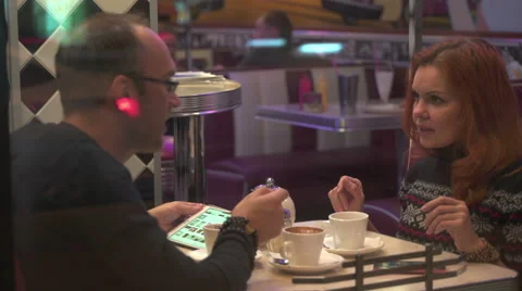 Couple with tablet in cafe talking to each other Stock Footage 68724589