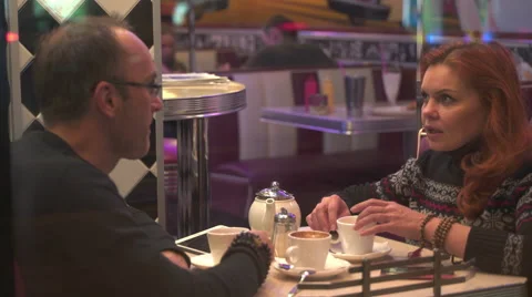 Couple with tablet in cafe talking to each other Stock Footage 68724645