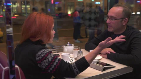 Couple with tablet in cafe talking to each other Stock Footage 68724745