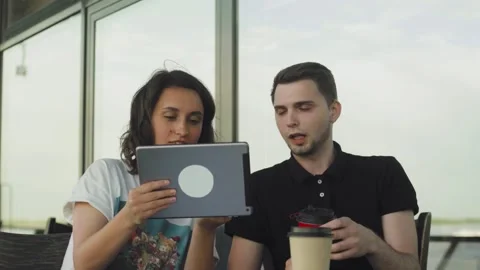 Couple with tablet computer fooling around in cafe in the city Stock Footage 131039748