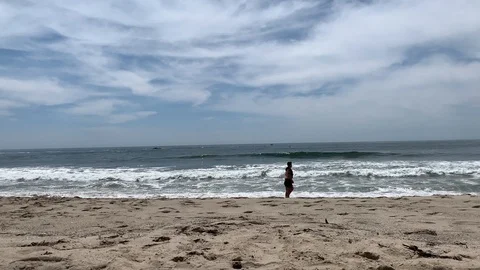 A couple take a walk on the beach. Stock Footage