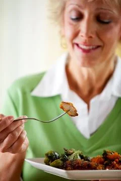 Couple: taking a bite of grilled chicken Stock Photos