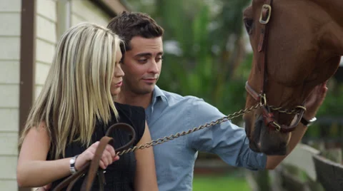 Couple taking care of a horse Stock-Footage 37925053