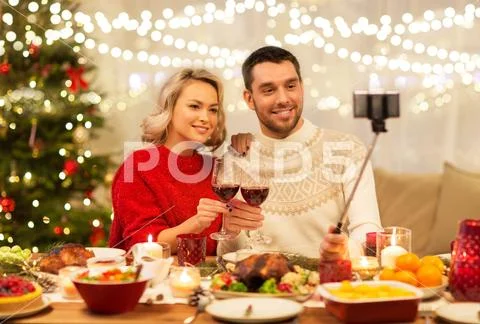 Couple taking picture by selfie stick at christmas Stock Photos