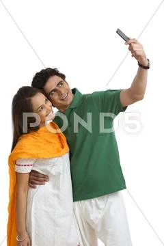 Couple taking a picture of themselves with a mobile phone Stock Photos