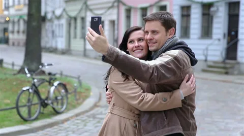 Couple taking self portrait with smartphone Stock Footage 33082436
