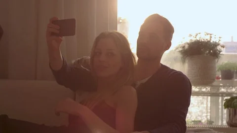 Couple taking a selfie on a couch   Stock Footage 111256230