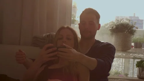 Couple taking a selfie on a couch   Stock Footage 111256267