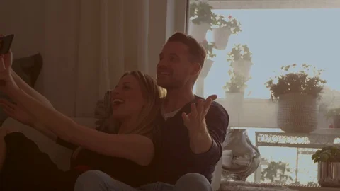 Couple taking a selfie on a couch   Stock Footage 111256290