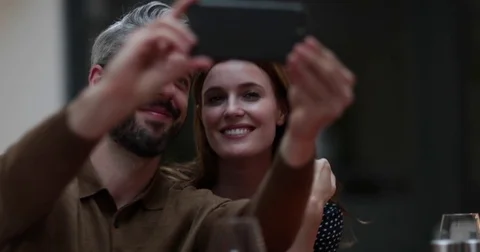 Couple taking selfie at dinner Stock Footage 80804978