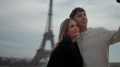 Couple taking selfie with Eiffel Tower in Paris France Young man and woman Stock Footage 325244357