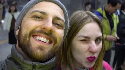 Couple taking selfie inside metro station 스톡 동영상 75683395