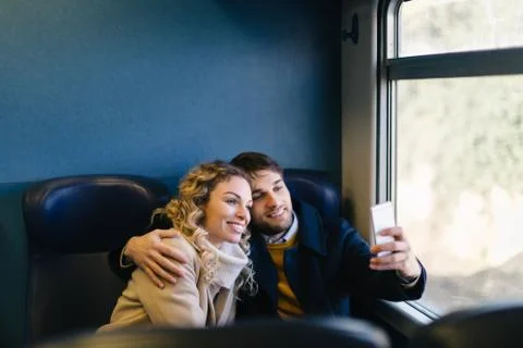 Couple taking selfie inside train Stock Photos
