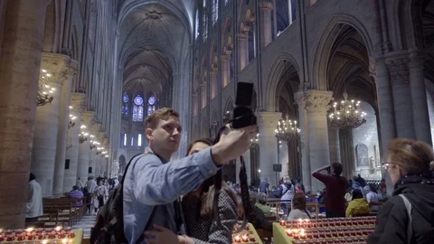 Couple taking selfie picture camera tourists Notre Dame Cathedral Paris Europe Stock Footage 94427679