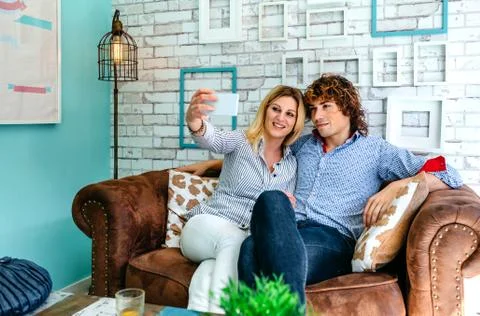Couple taking selfie on a sofa Stock Photos