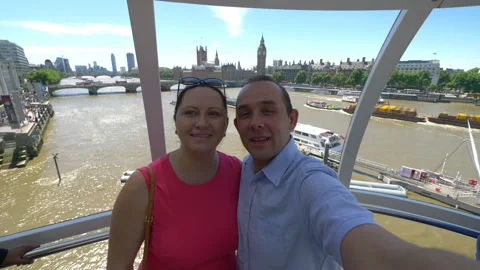 Couple taking selfie with a view of Big Ben in London in 4k slow motion Stock Footage 90070938