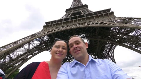 Couple taking selfie with view of Eiffel Tower in Paris in 4k slow motion 60fps Stock Footage 109427573