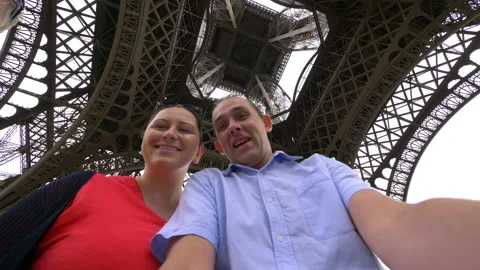 Couple taking selfie with view of Eiffel Tower in Paris in 4k slow motion 60fps Stock Footage 109427911