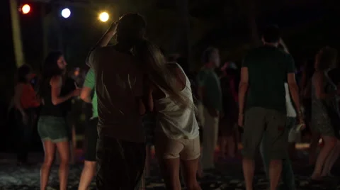 Couple taking selfies on a beach in Punta Cana at night Stock Footage 52463874