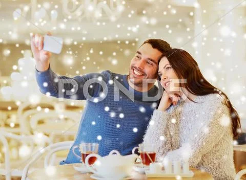 Couple taking smartphone selfie at cafe restaurant Stock Photos