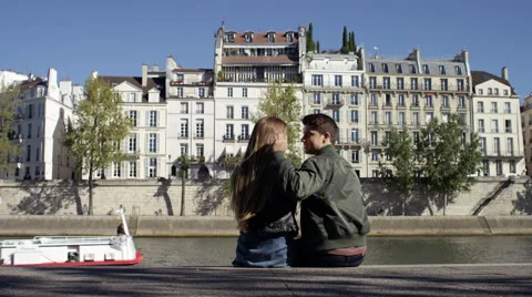 Couple taking some time to sit down and enjoy each others company while in Stock Footage 63030512