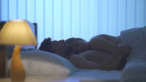 The couple talk in the bed. night time 库存影片 76883723