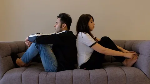 Couple talk seated with backs to each other having a discussion Stock Footage 100632113