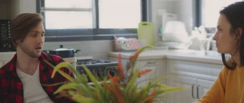 Couple talking about their relationship, sitting in the kitchen at home Stock Footage 131498066