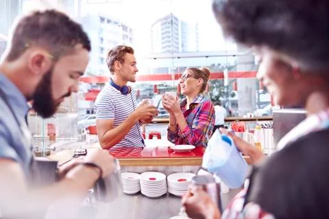 Couple talking and drinking coffee in cafe Stock Photos