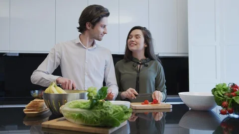 Couple talking and laughing in the kitchen Stock Footage 99941699