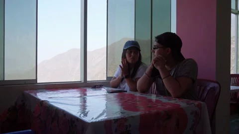 A couple talking and looking at a beautiful view of the mountains with the fresh Stock Footage 198760547