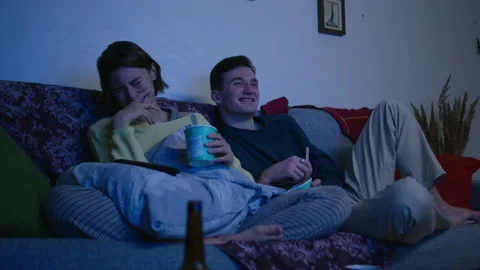 Couple is talking and smiling in front of TV. Couple is eating delivered food Stock Footage 143069404