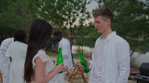 A couple talking and turning at the camera at the campsite in summer 스톡 동영상 197167841