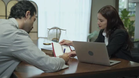 Couple talking and working with laptop computer together in office.  business Stock Footage 168665261