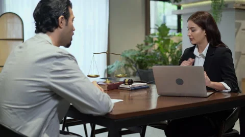 Couple talking and working with laptop computer together in office.  business Stock Footage 168665672