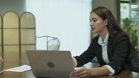 Couple talking and working with laptop computer together in office.  business Stock Footage 168665709