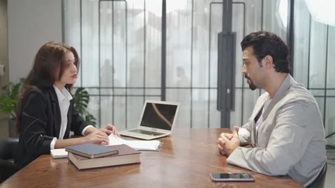 Couple talking and working with laptop computer together in office.  business Stock Footage 168667383