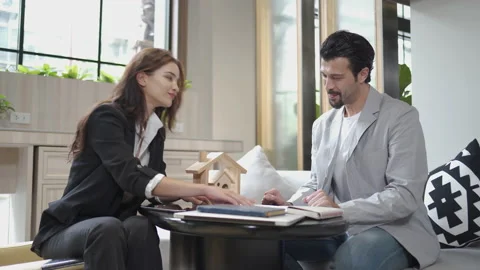 Couple talking and working with laptop computer together in office.  business Stock Footage 168669633