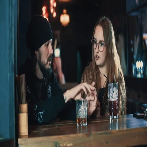 Couple talking at bar table 4k video. Young woman and man with beverage Stock Footage 69377446
