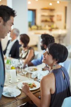 Couple talking at dinner party Stock Photos