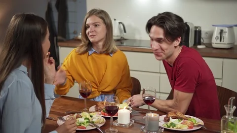 Couple talking to friend at dinner Stock Footage 114809997