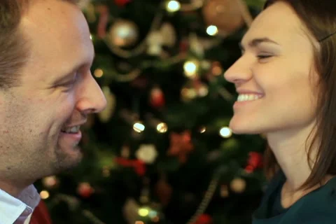 Couple talking in front of christmas tree, close up Stock Footage 10741879