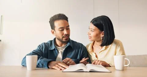 Couple, talking or Bible study for religion in home, coffee and scripture d.. Stock Photos