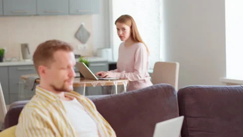 Couple talking over remote work at home Stock Footage 154727395