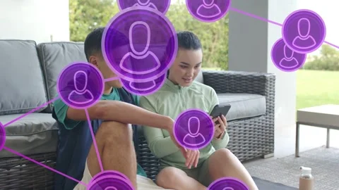 Couple talking on patio purple tech UI appearing woman reaching phone shooting Stock Footage 333632293