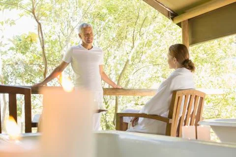 Couple talking on rustic balcony Stock Photos